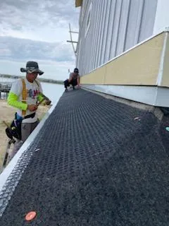 A group of men working on the roof of a building.