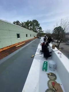 A group of people standing on top of a building.