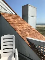 A chair and some chairs on the side of a building.