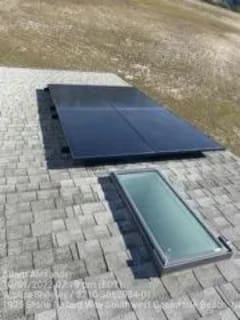 A solar panel on the roof of a house.